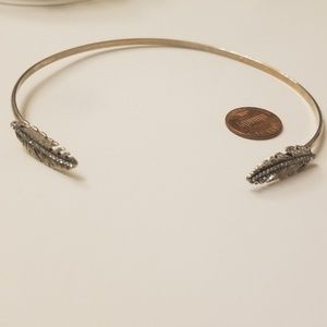 Feather quill at both ends Arm cuff